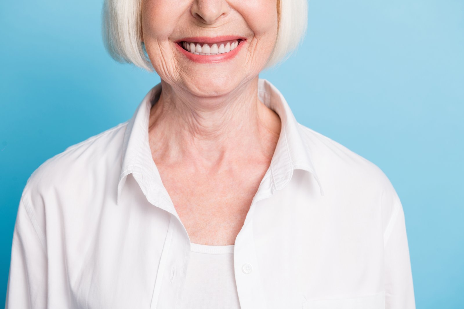 Smiling senior dental patient discussing denture options with their dentist